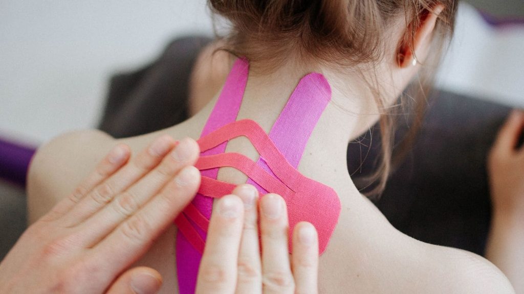 Pose de K-Taping, bandes adhésives thérapeutiques, par un kinésithérapeute du centre KINE’O à Marseille